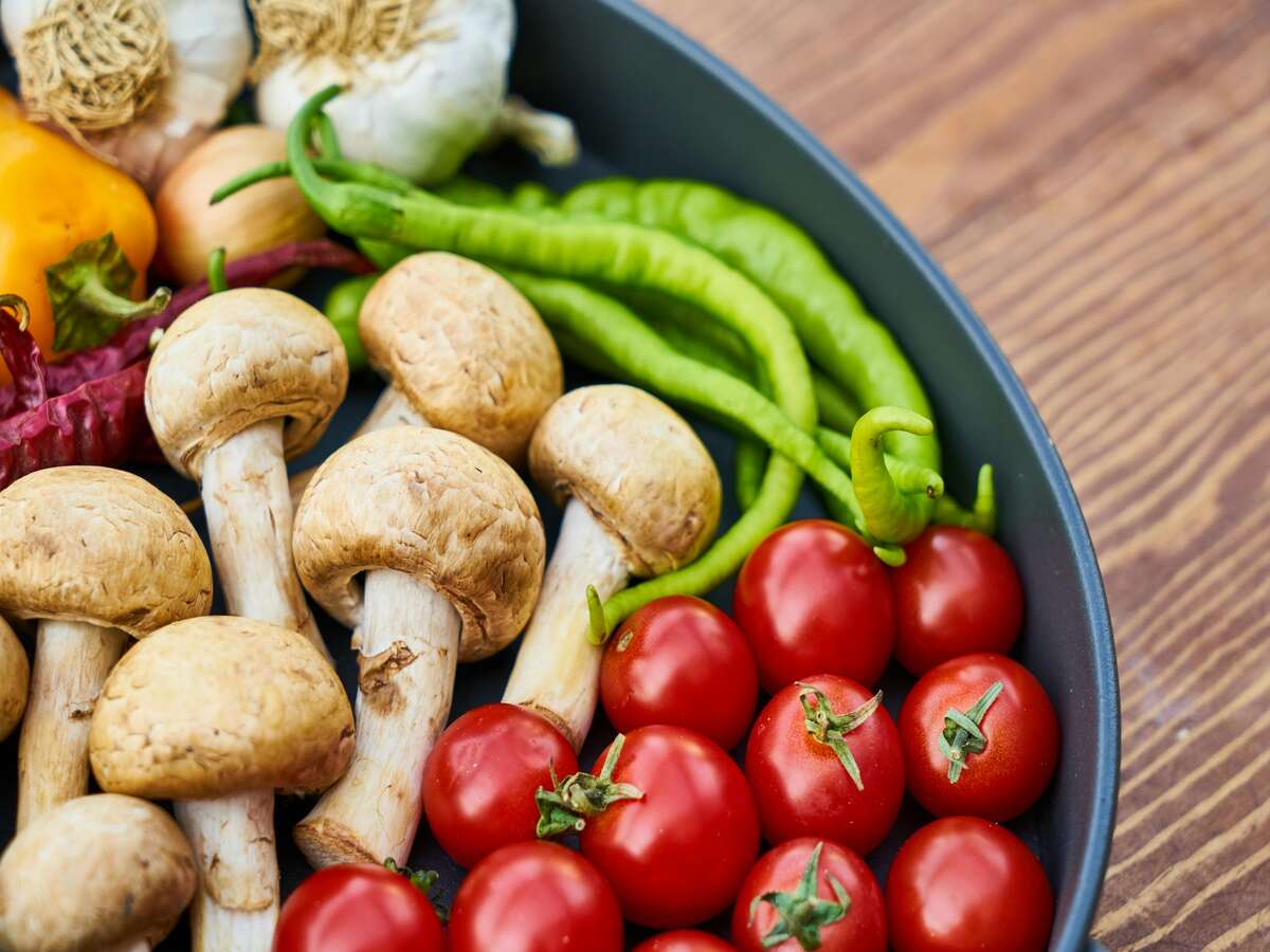 Tomatoes, garlic, and other acidic food in a cast iron pan.