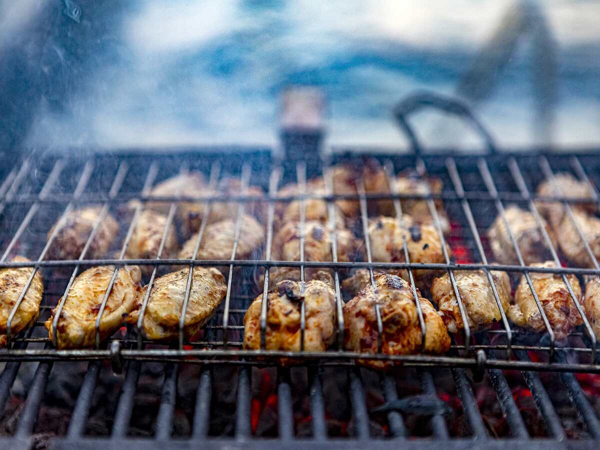 Chicken cooking on a charcoal grill.